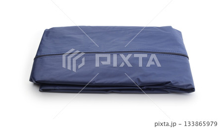 Folded raincoat isolated on white. 133865979