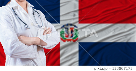 Doctor with crossed arms on Dominican Republic flag. Dominican health and care concept. Female doctor on Dominican Republic flag Doctor with crossed arms on Dominican Republic flag. Dominican health and care concept. Female doctor on Dominican Republic flag 133867173