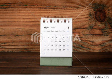 May 2026 Desk Calendar on Wooden Background Surface 133867559