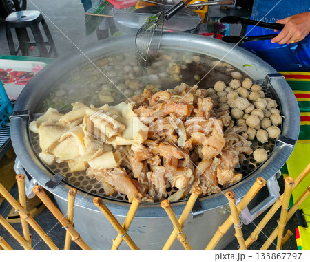 The image shows a street food stall preparing Bakso, a popular Indonesian meatball soup. 133867797