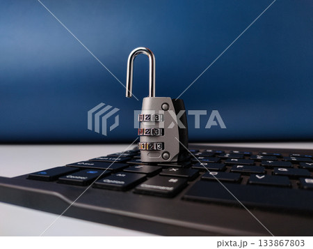 The image displays combination padlock resting on a computer keyboard, symbolizing digital security. 133867803