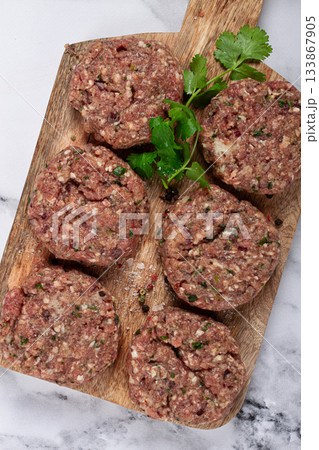 raw cutlets, minced meat, on a chopping board, homemade, top view, no people, raw cutlets, minced meat, on a chopping board, homemade, top view, no people, 133867905