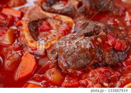 ossobuco stew with vegetables, knuckle on the bone with new potatoes, in tomato sauce,homemade, top view, no people, 133867914