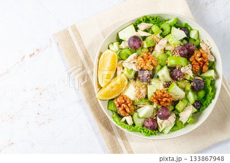 Fresh Waldorf salad, celery stalk with chicken, apple and walnuts, grapes, herbs, homemade, without people, Fresh Waldorf salad, celery stalk with chicken, apple and walnuts, grapes, herbs, homemade, without people, 133867948