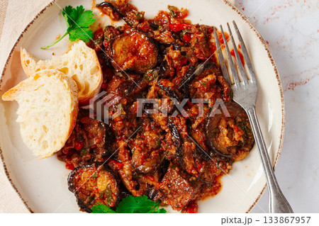 stewed meat with eggplant is a Georgian dish, on a light background,homemade, no people stewed meat with eggplant is a Georgian dish, on a light background,homemade, no people 133867957