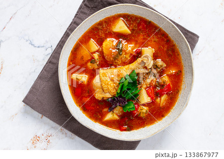 Souzi soup. Georgian dish, meat with oats, tomato sauce and herbs, 133867977