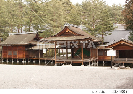 松林を背に浮かぶ池上の雅な能舞台と白砂の庭園  133868053