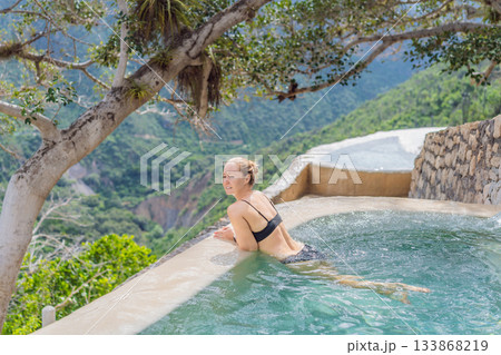 Female tourist exploring Grutas Tolantongo in Mexico, enjoying natural hot springs, scenic caves, and outdoor adventure. Travel, wellness, and sightseeing concept Female tourist exploring Grutas Tolantongo in Mexico, enjoying natural hot springs, scenic caves, and outdoor adventure. Travel, wellness, and sightseeing concept 133868219