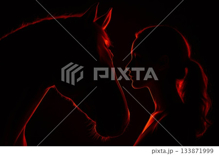 Profile of horse's head and girl's face illuminated by red light, creating a dramatic and emotional silhouette against a black background Profile of horse's head and girl's face illuminated by red light, creating a dramatic and emotional silhouette against a black background 133871999