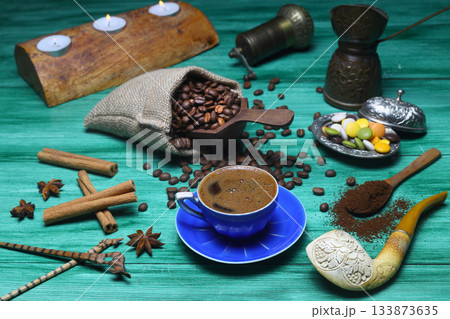Turkish coffee concept. Copper pot (Cezve), vintage coffee grinder, coffee beans on a dark wooden background. 133873635