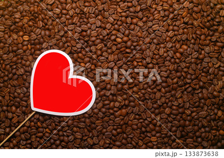 red heart shape on roasted coffee beans background 133873638