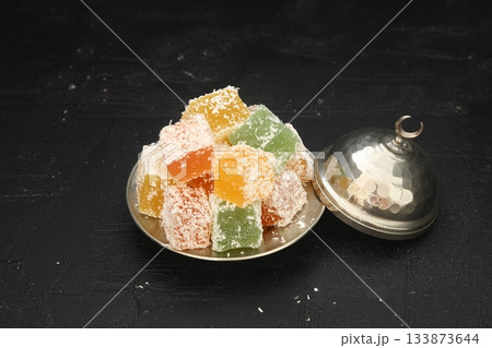 Turkish delight dessert in plate on black background 133873644