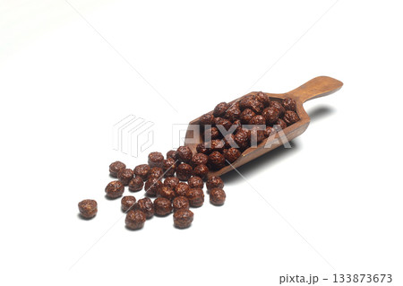 Healthy cereal breakfast. Mixed muesli in wooden scoop isolated on white background. 133873673