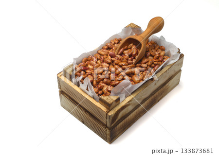 Kidney beans in a small wooden crate, isolated on white background. With wooden spoon. Kidney beans in a small wooden crate, isolated on white background. With wooden spoon. 133873681