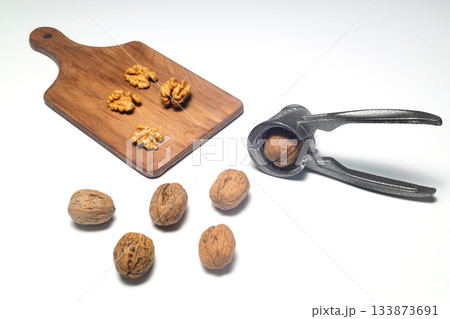 Walnuts with nutcracker isolated on white background 133873691