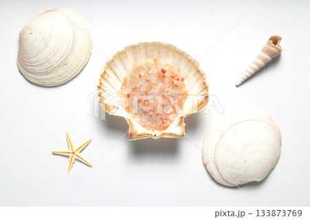 Himalayan salt in a seashell. Isolated on white background. Himalayan salt in a seashell. Isolated on white background. 133873769