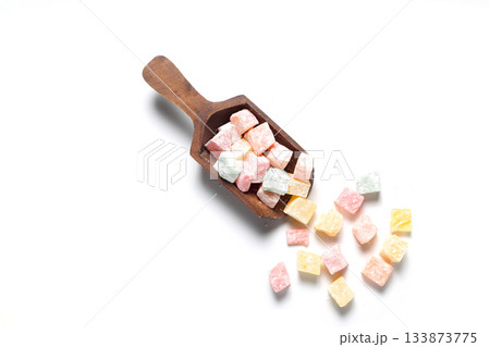 Colorful Turkish Delights in a wooden scoop. isolated on white background Colorful Turkish Delights in a wooden scoop. isolated on white background 133873775