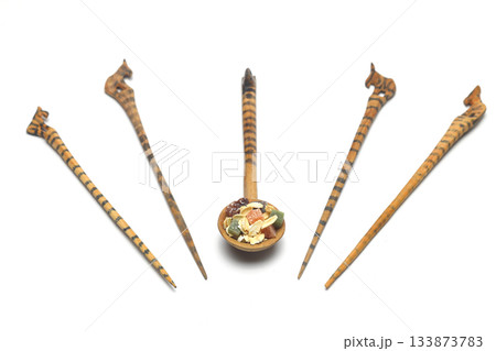 Oat flakes in wooden spoon isolated on White background. Heap of oats for package of oatmeal or granola. Selective Focus. 133873783