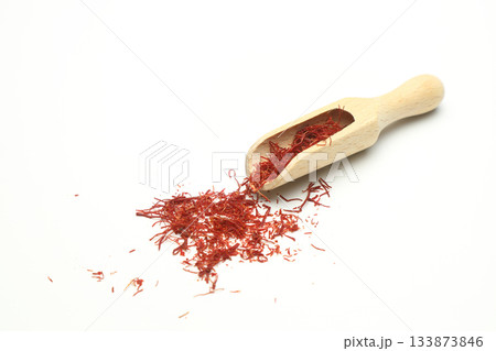 top view of crocus saffron threads in wood scoop isolated on white background 133873846