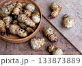Fresh Sliced Jerusalem Artichokes on Wooden Cutting Board 133873889
