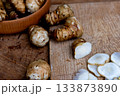 Fresh Sliced Jerusalem Artichokes on Wooden Cutting Board 133873890