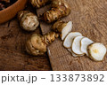 Fresh Sliced Jerusalem Artichokes on Wooden Cutting Board 133873892