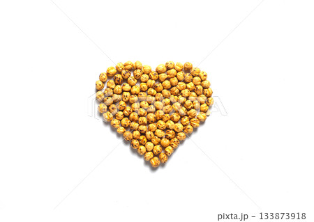 Heart shape Leblebi or Roasted Chickpea on a white background. Healthy organic food high in fibre, vitamins, minerals, protein. On white background. Flat lay, top view. Heart shape Leblebi or Roasted Chickpea on a white background. Healthy organic food high in fibre, vitamins, minerals, protein. On white background. Flat lay, top view. 133873918