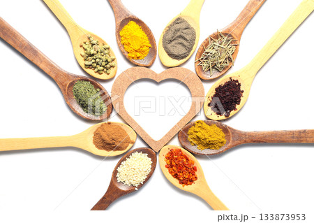 Different kind of spices on a white background. Oriental spices in spoons, red peppers, curry powder, cinnamon powder, mint powder, sumac, sesame, black cumin, Different kind of spices on a white background. Oriental spices in spoons, red peppers, curry powder, cinnamon powder, mint powder, sumac, sesame, black cumin, 133873953