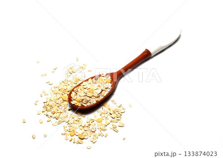 Breakfast cereals in wooden spoon. Healthy muesli with oat flakes, nuts and raisins isolated on white background. Breakfast cereals in wooden spoon. Healthy muesli with oat flakes, nuts and raisins isolated on white background. 133874023
