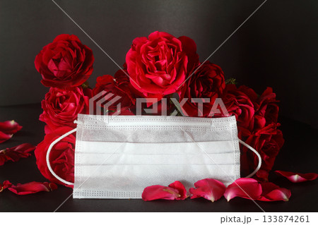red roses and n95 mask on a black background 133874261