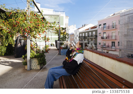 Luminous balcony scene with woman reading and capturing moments Luminous balcony scene with woman reading and capturing moments 133875538
