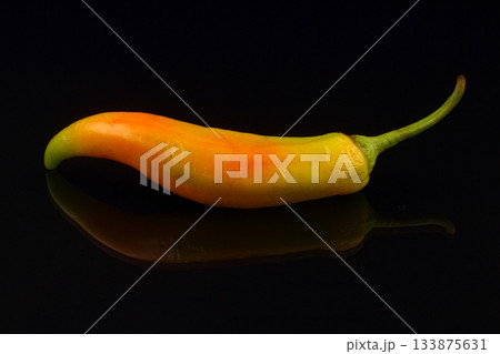 red hot chili pepper on black background. red hot chili pepper on black background. 133875631