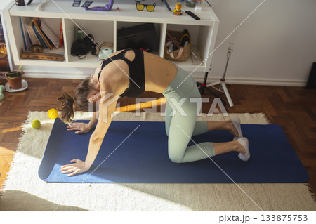 caucasian woman doing resistance band shoulder stretch caucasian woman doing resistance band shoulder stretch 133875753