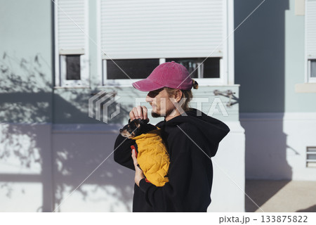 Parent with child, Mother or father managing baby carrier outdoors 133875822