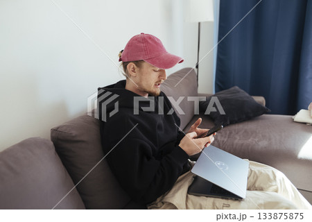 Person managing messages and analytics simultaneously at residence Person managing messages and analytics simultaneously at residence 133875875