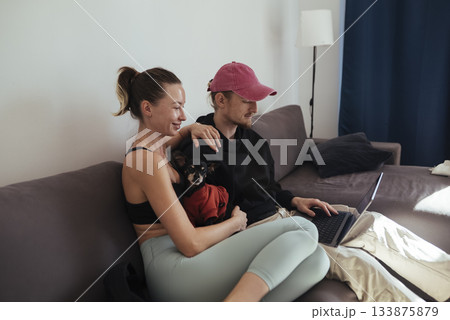 Laughter shared by couple during relaxing evening entertainment Laughter shared by couple during relaxing evening entertainment 133875879