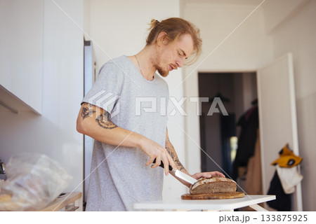 Individual slicing bread on countertop with peaceful planning attitude 133875925