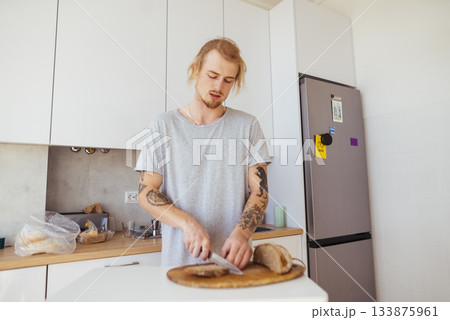 Individual preparing meal with rustic tools and modern decor Individual preparing meal with rustic tools and modern decor 133875961