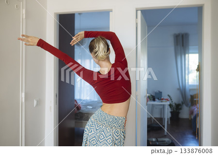 Graceful female dancer with vibrant clothing captured from behind 133876008