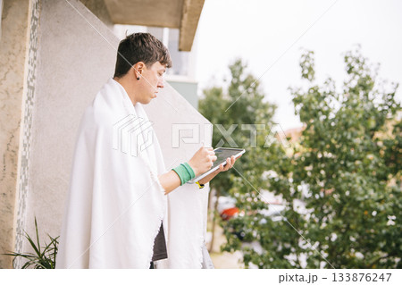 Man on balcony developing entrepreneurial ideas with notes and sketches 133876247