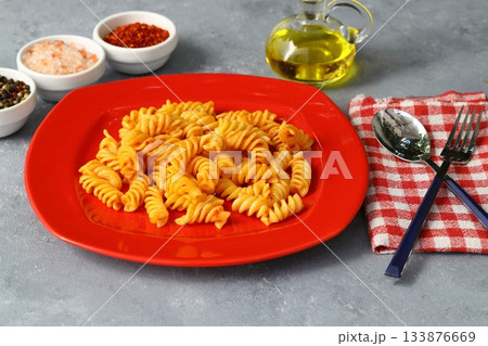 Fusilli pasta in tomato sauce. gray background. Italian food concept 133876669