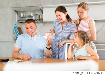 Disgruntled wife and teenage daughters demanding for money from upset man 133878021