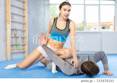 Adult man and young woman training self-defense techniques Adult man and young woman training self-defense techniques 133878101