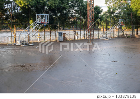 Basketball court having damaged by mud flooded after Kok river rising and flooding Chiang Rai province, Thailand. Basketball court having damaged by mud flooded after Kok river rising and flooding Chiang Rai province, Thailand. 133878139