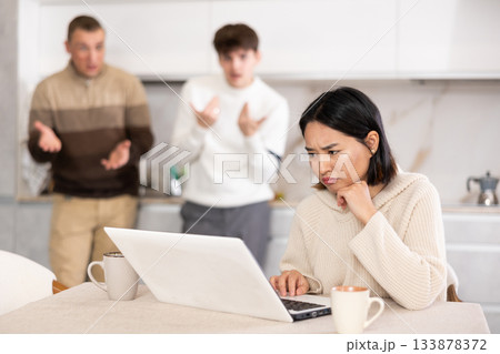 Guy and man quarrel with young woman with laptop Guy and man quarrel with young woman with laptop 133878372