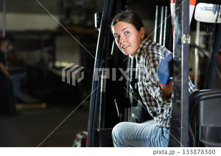 Young female worker working on forklift at metallurgical plant Young female worker working on forklift at metallurgical plant 133878380