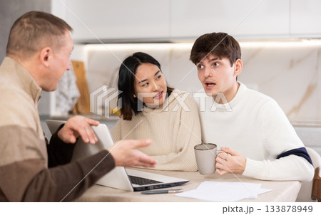 Experienced male agent offers to issue an insurance policy or take out financial loan for spouses at home 133878949
