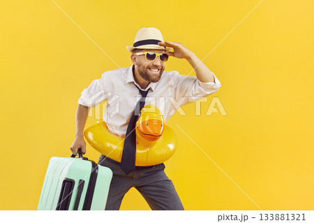 Happy man in office wear, sun hat, luggage with rubber inflatable duck ring summer holiday dream Happy man in office wear, sun hat, luggage with rubber inflatable duck ring summer holiday dream 133881321