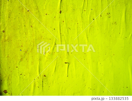 Wrinkled lime green textured wall with scattered debris 133882535
