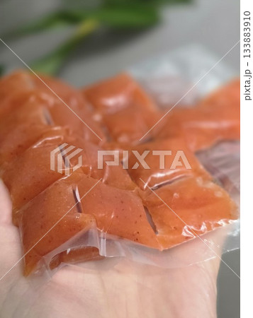 Hand Holding Orange Portion Pouches for Freezing Hand Holding Orange Portion Pouches for Freezing 133883910